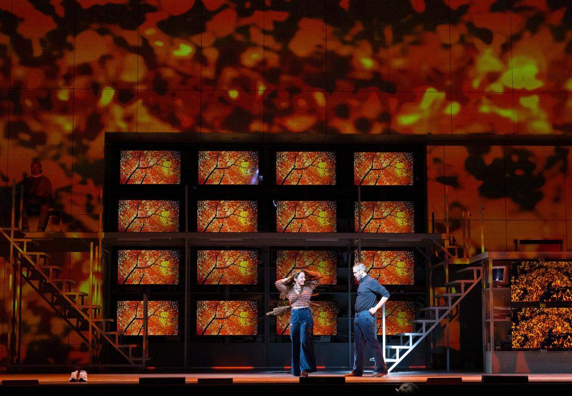 “The set can transform from an apple orchard to the Apple corporate headquarters,” says composer Mason Bates. In this scene, Steve Jobs is with his former romantic partner, Chrisann Brennan.