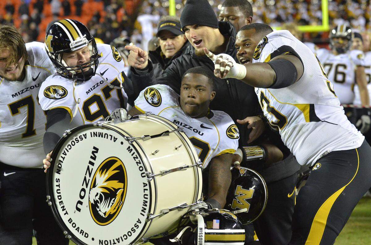 Missouri wide receiver Jerrell Jackson (No. 29), offensive linemen Mark Hill (73) and Dan Hoch (77) and kicker Trey Barrow (97) celebrated after the Tigers beat the Kansas Jayhawks 24-10 in the most recent Border War football game on Nov. 26, 2011 at Arrowhead Stadium.