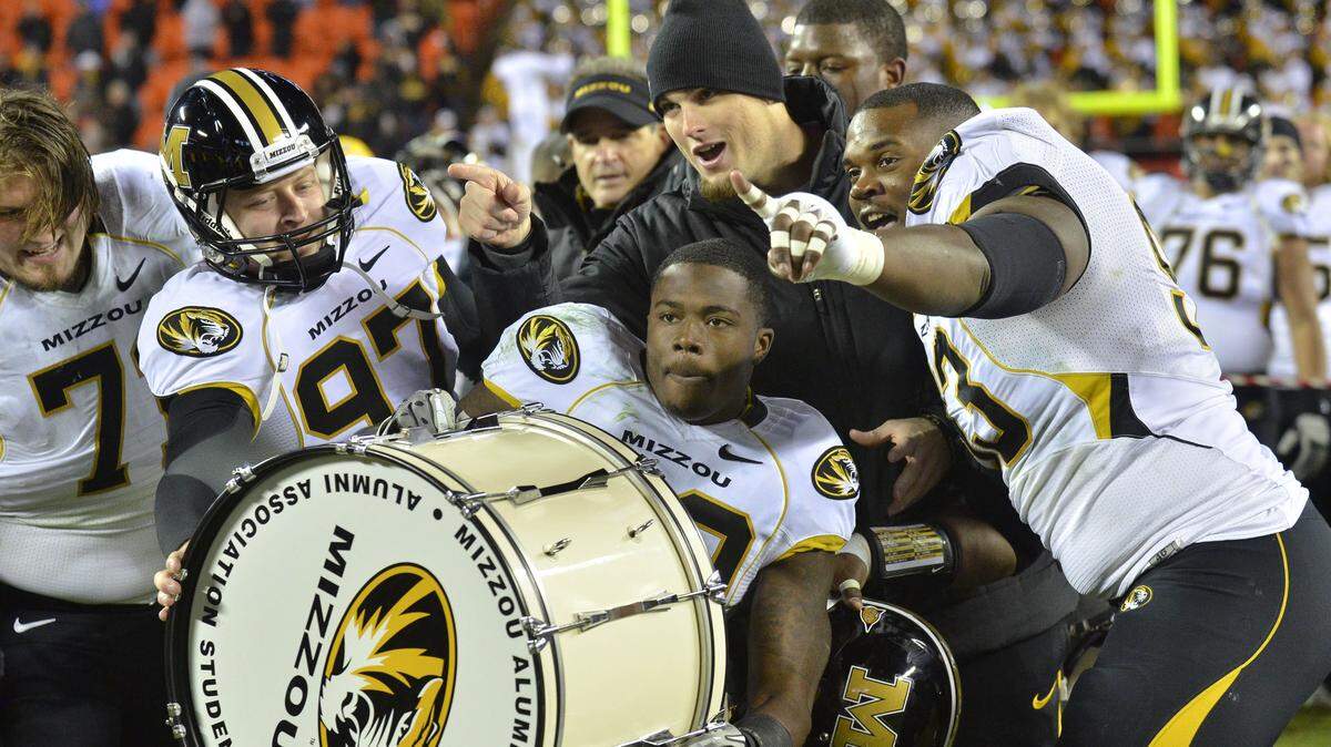 Missouri wide receiver Jerrell Jackson (No. 29), offensive linemen Mark Hill (73) and Dan Hoch (77) and kicker Trey Barrow (97) celebrated after the Tigers beat the Kansas Jayhawks 24-10 in the most recent Border War football game on Nov. 26, 2011 at Arrowhead Stadium.