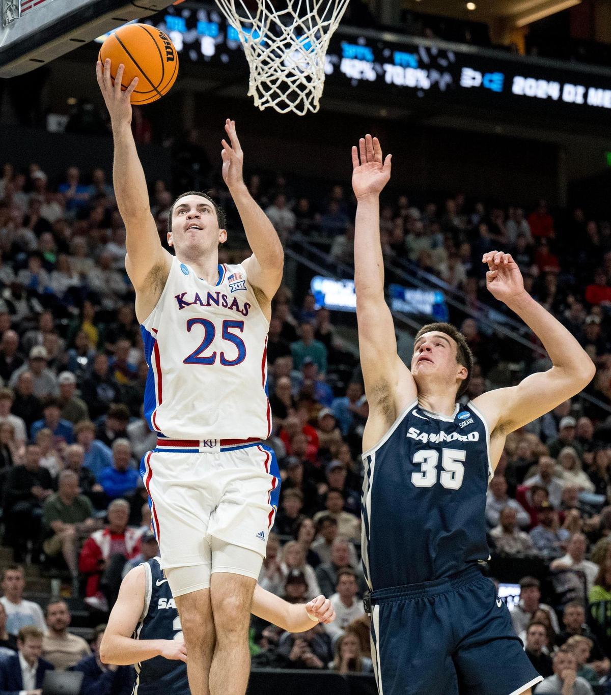Kansas Jayhawks guard Nicolas Timberlake (25) shoots a layup as Samford Bulldogs center Riley Allenspach (35) contests the shot during a men’s college basketball game in the first round of the NCAA Tournament on Thursday, March 21, 2024, in Salt Lake City, Utah.