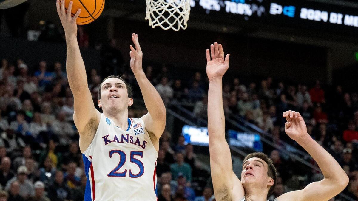 Kansas Jayhawks guard Nicolas Timberlake (25) shoots a layup as Samford Bulldogs center Riley Allenspach (35) contests the shot during a men’s college basketball game in the first round of the NCAA Tournament on Thursday, March 21, 2024, in Salt Lake City, Utah.
