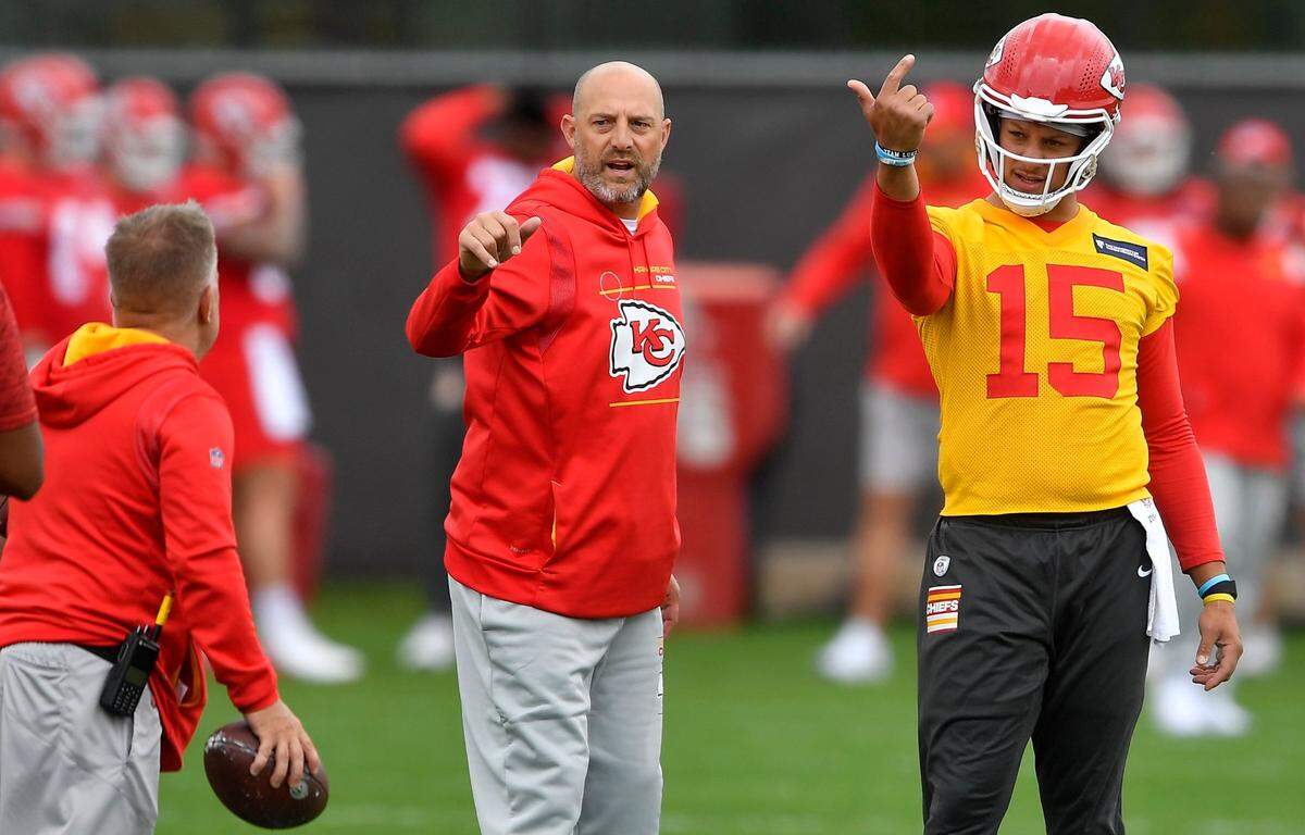 Quarterback coach Matt Nagy, left, and quarterback Patrick Mahomes signal to receivers during practice this May at the Chiefs’ practice facility.