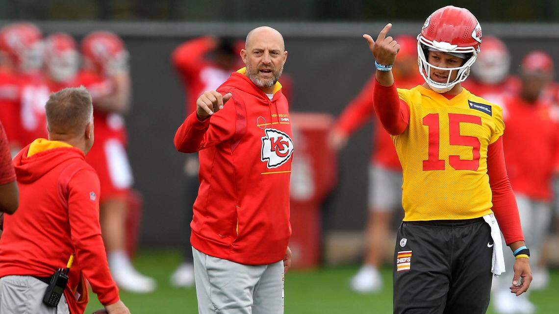 Quarterback coach Matt Nagy, left, and quarterback Patrick Mahomes signal to receivers during practice this May at the Chiefs’ practice facility.