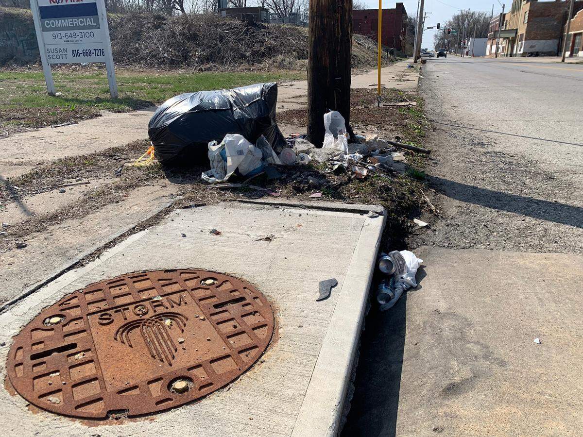 A bag of trash left by a vacant lot in the Ivanhoe neighborhood in Kansas City.
