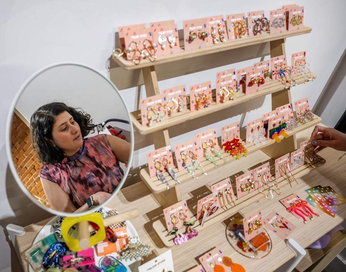 Paulina Otero is seen reflected in a mirror as she speaks about the variety of jewelry displayed in her studio on Tuesday, March 3, 2026, in Kansas City.