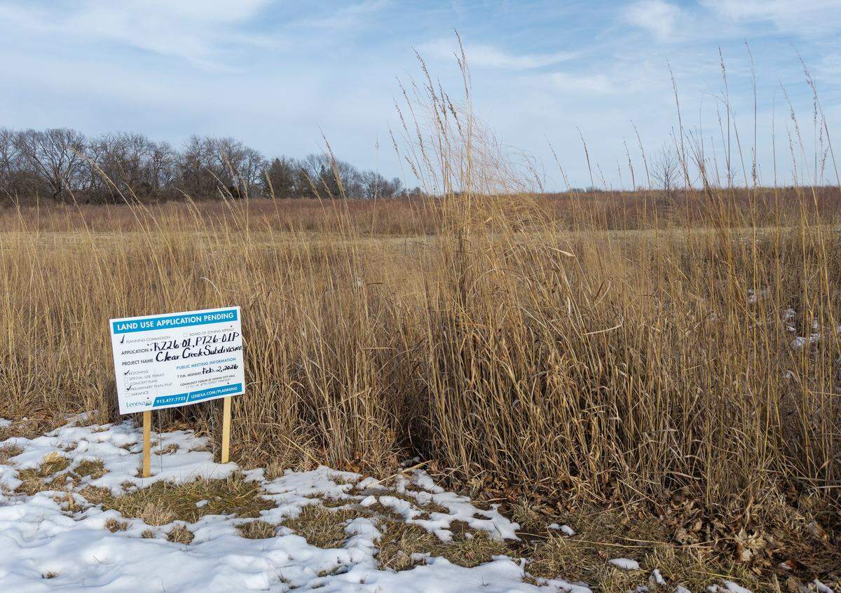 A sign alerting residents to a proposed 50-home Habitat for Humanity development is seen on Monday, Feb. 2, 2026, at the Clear Creek Trail area in Lenexa. Located off Clare Road near 86th Terrace, the site features a walking trail that leads to a small lake and a surrounding wetlands area.
