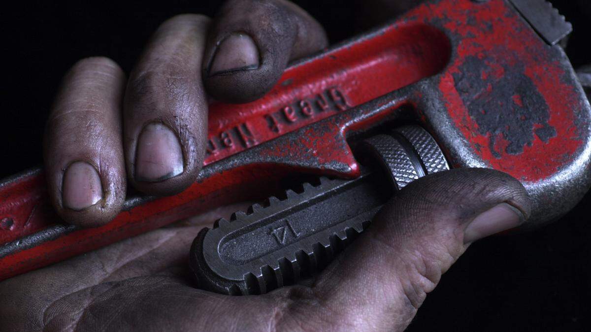 The hands of Warren Kelsey, 44, grips a wrench at the KCATA where he is a city bus mechanic. ``We cater to the immediate needs of the bus to keep it safe and running,’’ said Kelsey. ``The good thing about fixing things is that you get instant satisfaction,’’ said Kelsey. ``You don’t have to wait and hear that you did a good job, you can tell right away.’’ photo by David Pulliam  Scenes from the City. An occasional visual essay about the people and places in the city. Hands. Labor Day. CUTLINE Hands of Labor. Workers in Kansas City use their hands to support and solace bus riders, children, customers and patients. On the cover, the hand of Warren Kelsey gripped a wrench at the Kansas City Area Transportation Authority, where he is a mechanic.