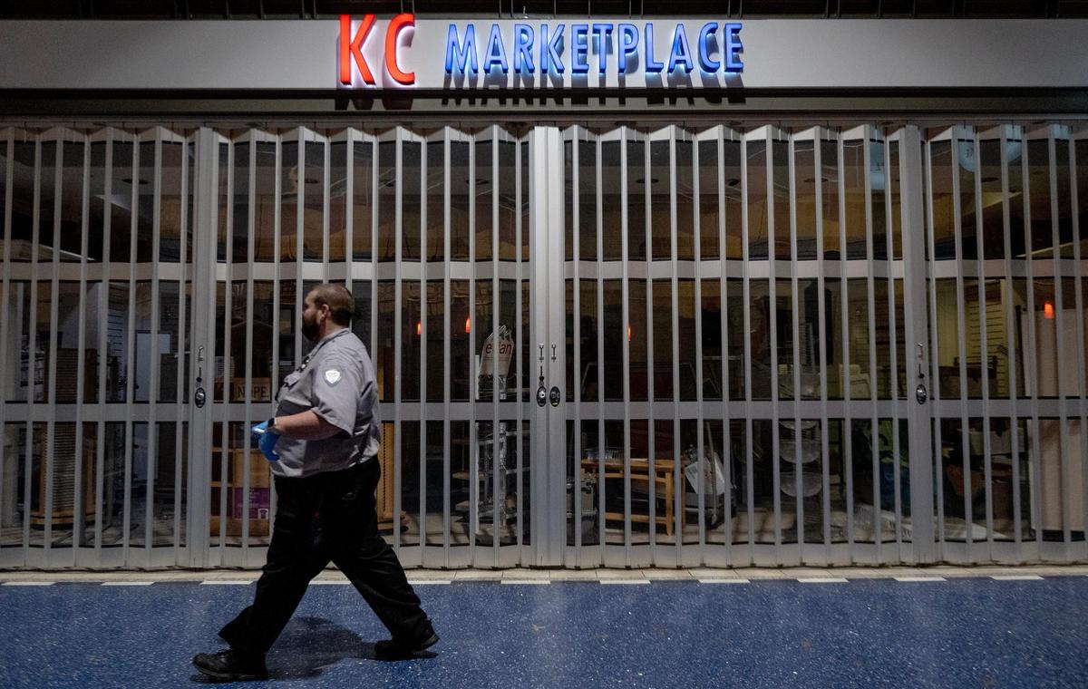 A security worker walks past an empty KC Marketplace shop inside terminal B on the last day of operation at Kansas City International Airport’s old terminals on Monday, Feb. 27, 2023, in Kansas City.