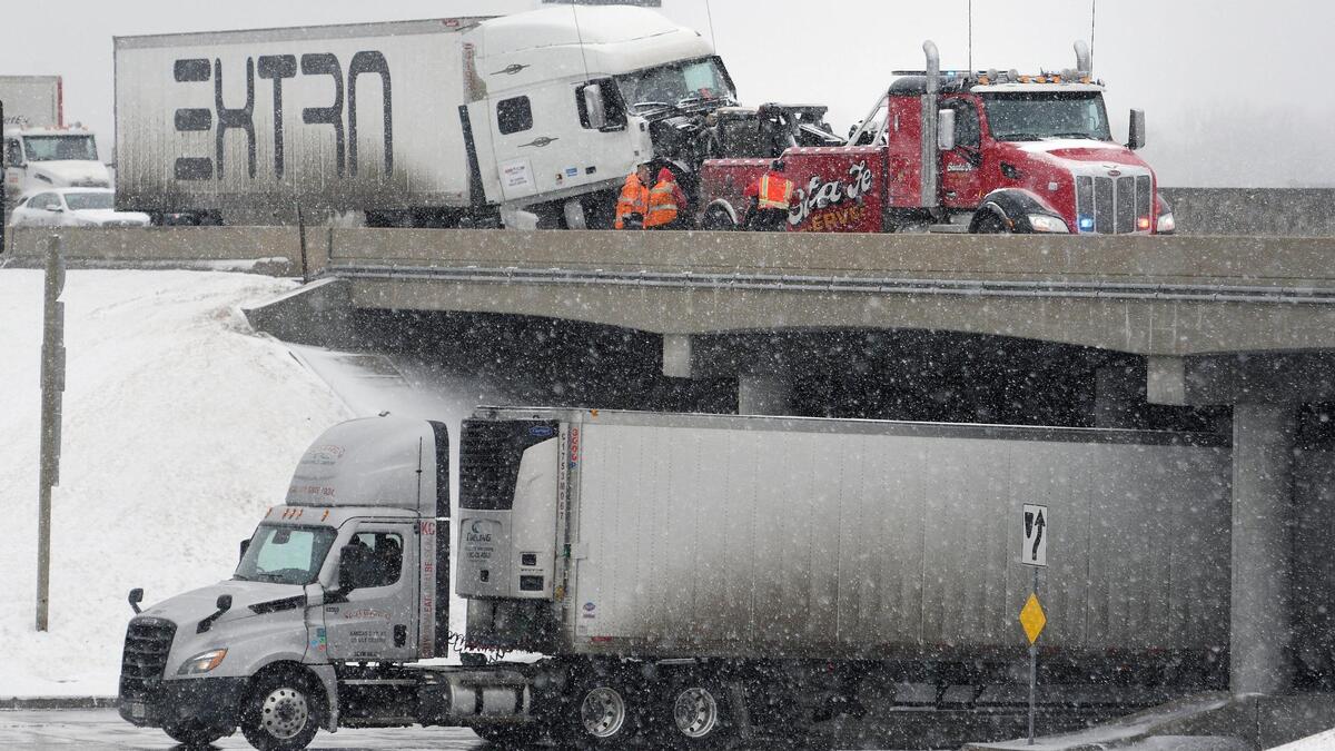 Tow truck operators worked to hook up a semi truck that wrecked during wintry weather on Interstate 35 in near 67th Street on Thursday, March 10, 2022, in Overland Park. The semi was towed from the scene after the highway was briefly impacted by the wreck.