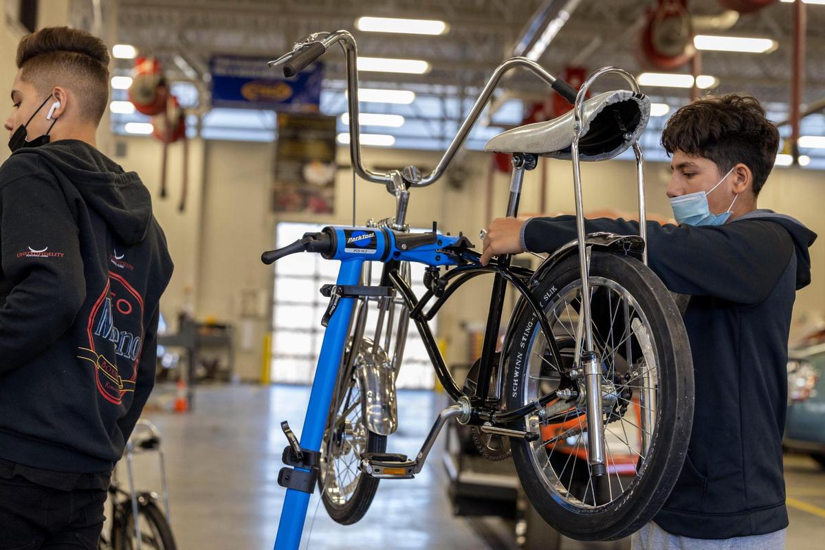 Alexandro Rodriquez builds a kit bike, a replica of a 1970s Schwinn Stingray, at Olathe Advanced Technical Center, during the weekly lowrider bike club. Students start by building a basic bike before moving on to more complicated skills.