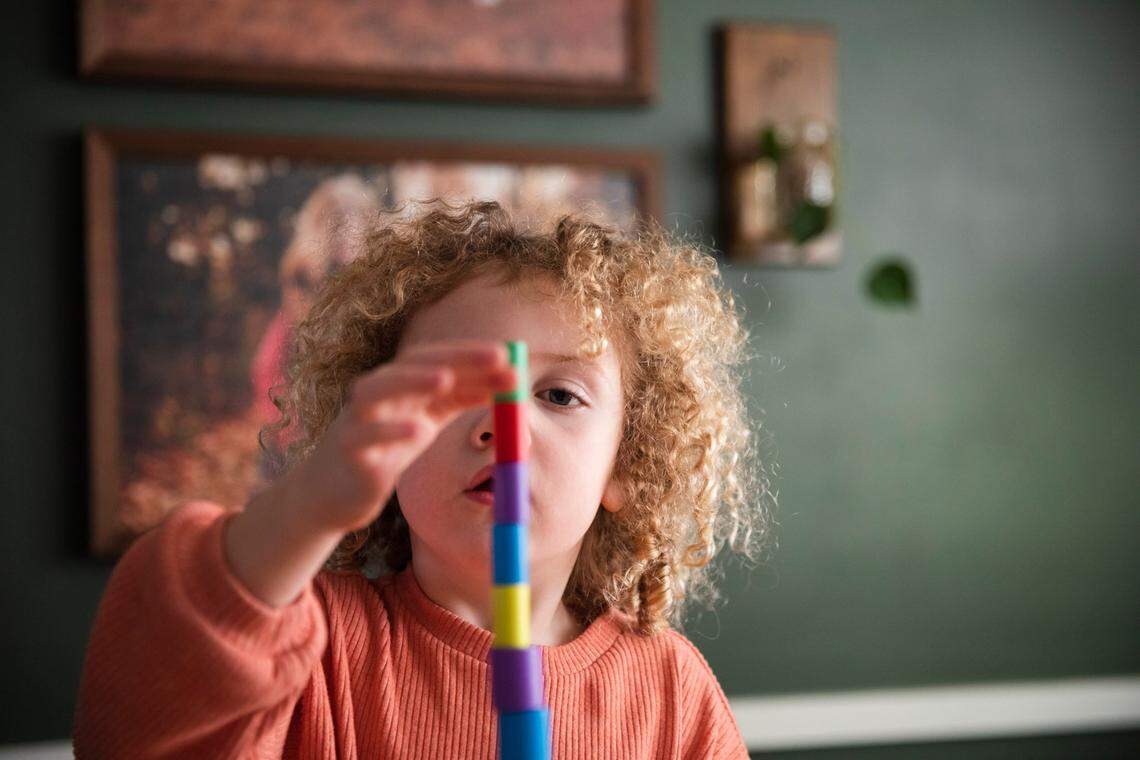 Amira Prier plays near parent educator Debra Stevenson and her mother, Mia.