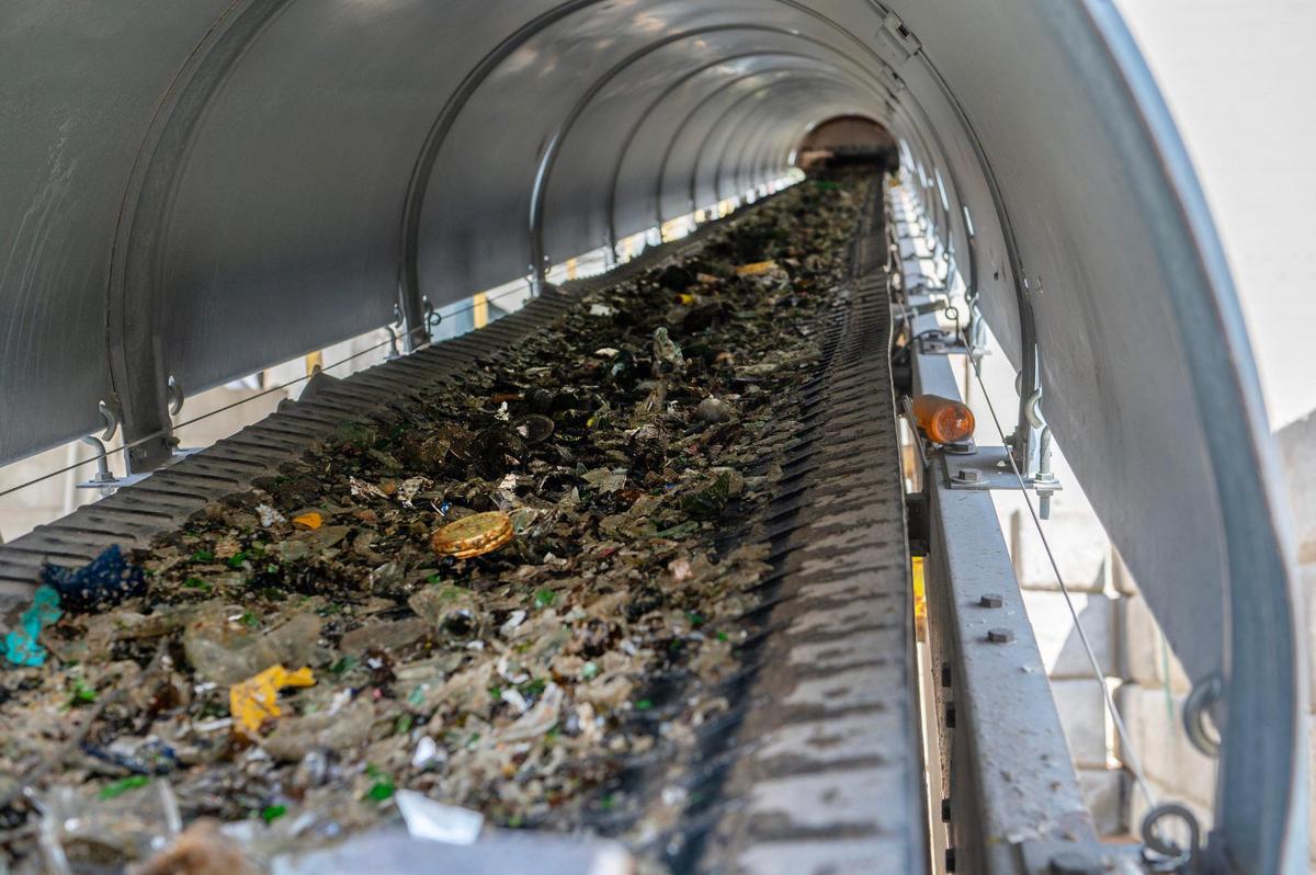 Glass materials are seen going up a conveyor belt into the Ripple Glass processing facility on Wednesday, March 15, 2023, in Kansas City.