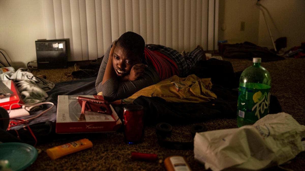 Shavannaha Bryers watched a movie on a friend’s phone. As a former foster youth, Bryers has been in and out of homelessness for the past three years.