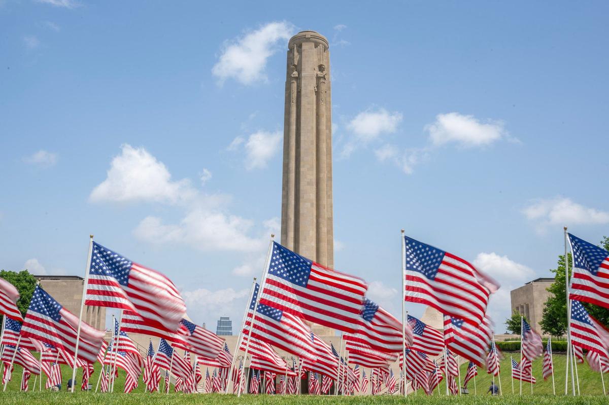 140 U.S flags are displayed in front of the Liberty Memorial Tower, each representing a veteran lost to suicide in one week, at the National WWI Museum and Memorial on Friday, May 24, 2024, in Kansas City.