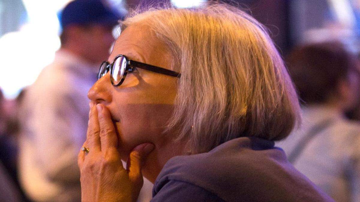 At Westport Ale House, Mary Buchanan of Kansas City watches the first inning of game one in dejection.
