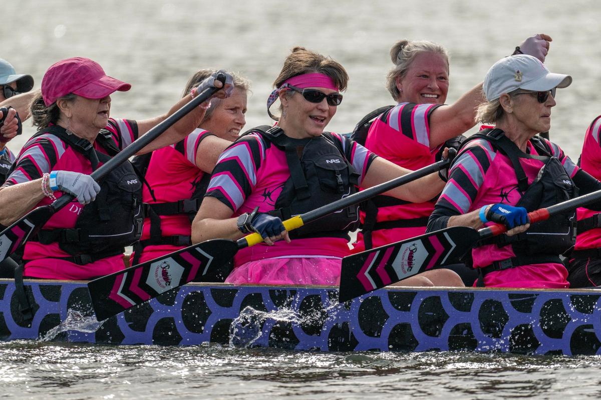 Crew members of Prairie Dragon Paddlers paddle in a qualifying race during the KC Dragon Boat Festival on Saturday, Sept. 28, 2024, at Shawnee Mission Park.