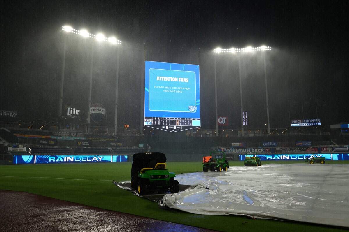 KANSAS CITY, MISSOURI - JUNE 13: Heavy rain falls as the scoreboard alerts fans to take cover during a delay in the game between Houston Astros and Kansas City Royals at Kauffman Stadium on June 13, 2026 in Kansas City, Missouri. (Photo by Ed Zurga/Getty Images)