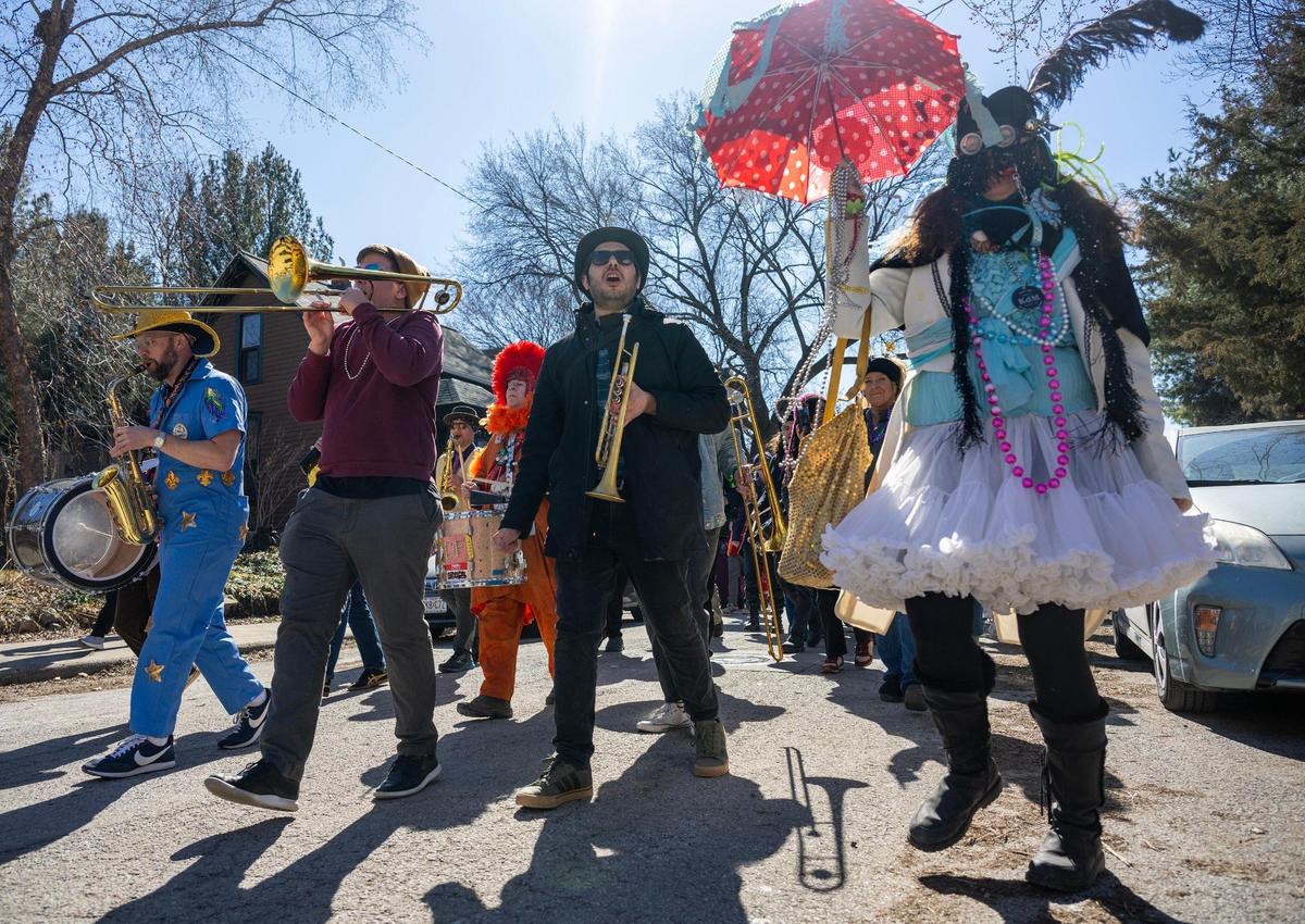 Members of the Sass-a-Brass band play music along Summit Street during the annual Krewe de Prank parade on Sunday, March 2, 2025, in Kansas City.