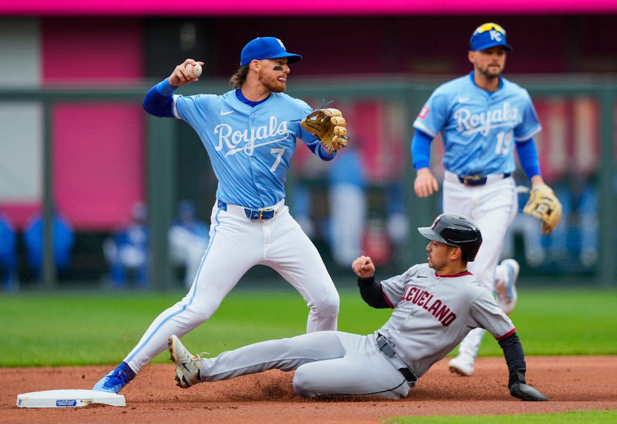 Kansas City Royals shortstop Bobby Witt Jr. throws to first base after forcing out Cleveland Guardians left fielder Steven Kwan during a game at Kauffman Stadium on Sunday, March 30, 2025.