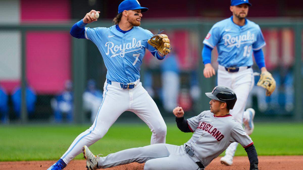 Kansas City Royals shortstop Bobby Witt Jr. throws to first base after forcing out Cleveland Guardians left fielder Steven Kwan during a game at Kauffman Stadium on Sunday, March 30, 2025.