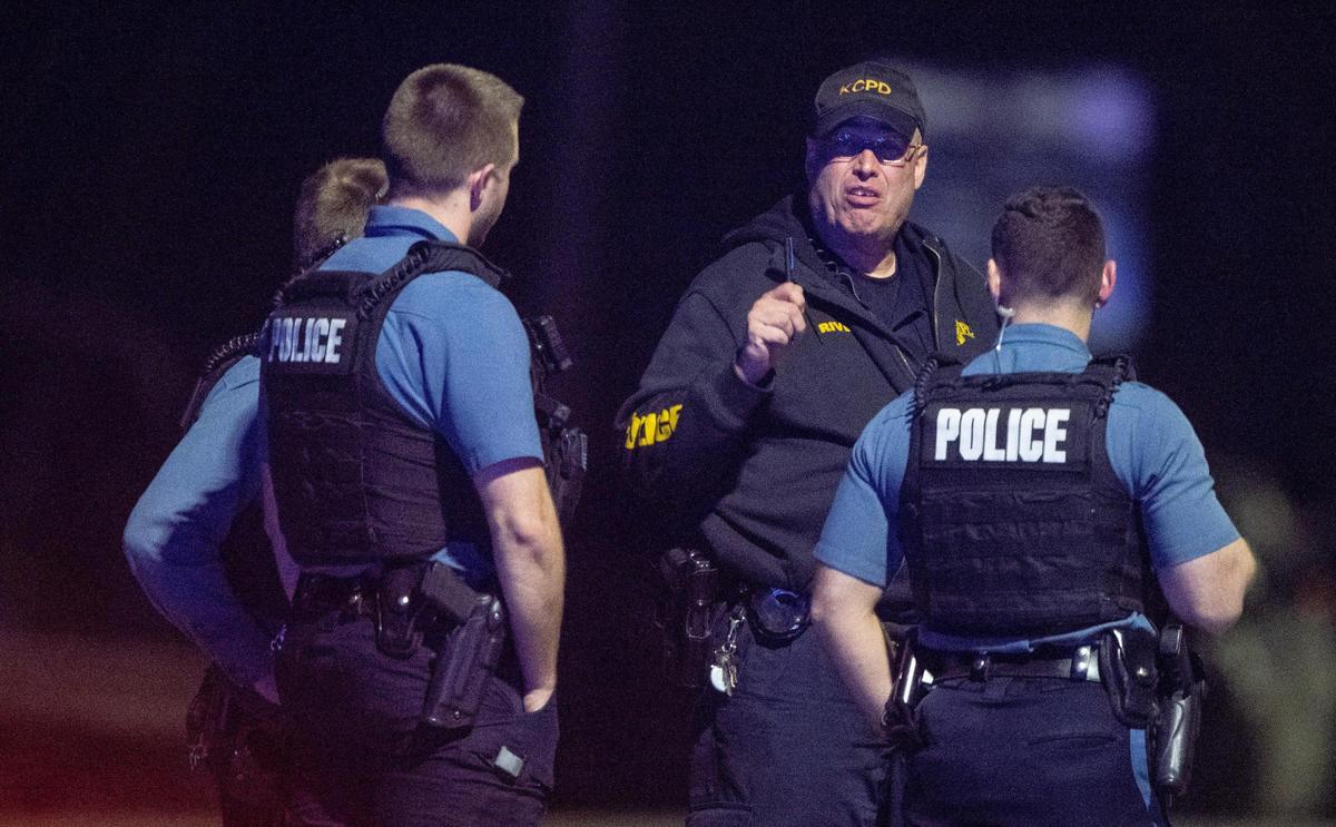 Kansas City police officers talk near the scene of a standoff in the 2300 block of Blue Ridge Boulevard on Tuesday.