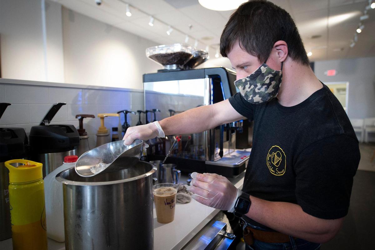 Patrick Chapman, a barista and a super scooper at The Golden Scoop, mixes a vanilla iced latte. “It’s actually so much fun,” said Chapman, 25. “I’m actually enjoying myself making coffee.”