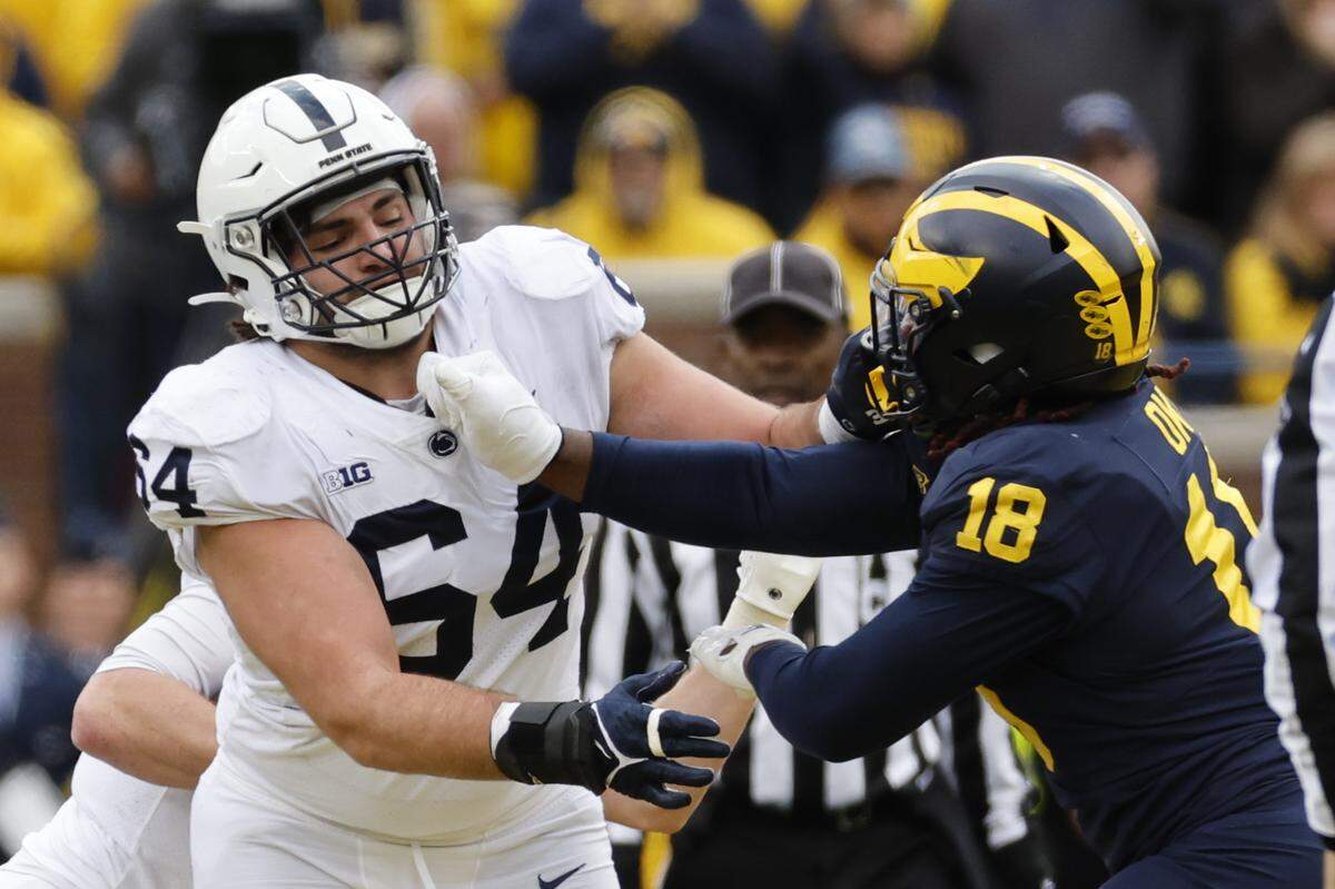 Penn State Nittany Lions offensive lineman Hunter Nourzad (64) blocks Michigan Wolverines linebacker Eyabi Okie (18) in the second half at Michigan Stadium on Oct. 15, 2022.