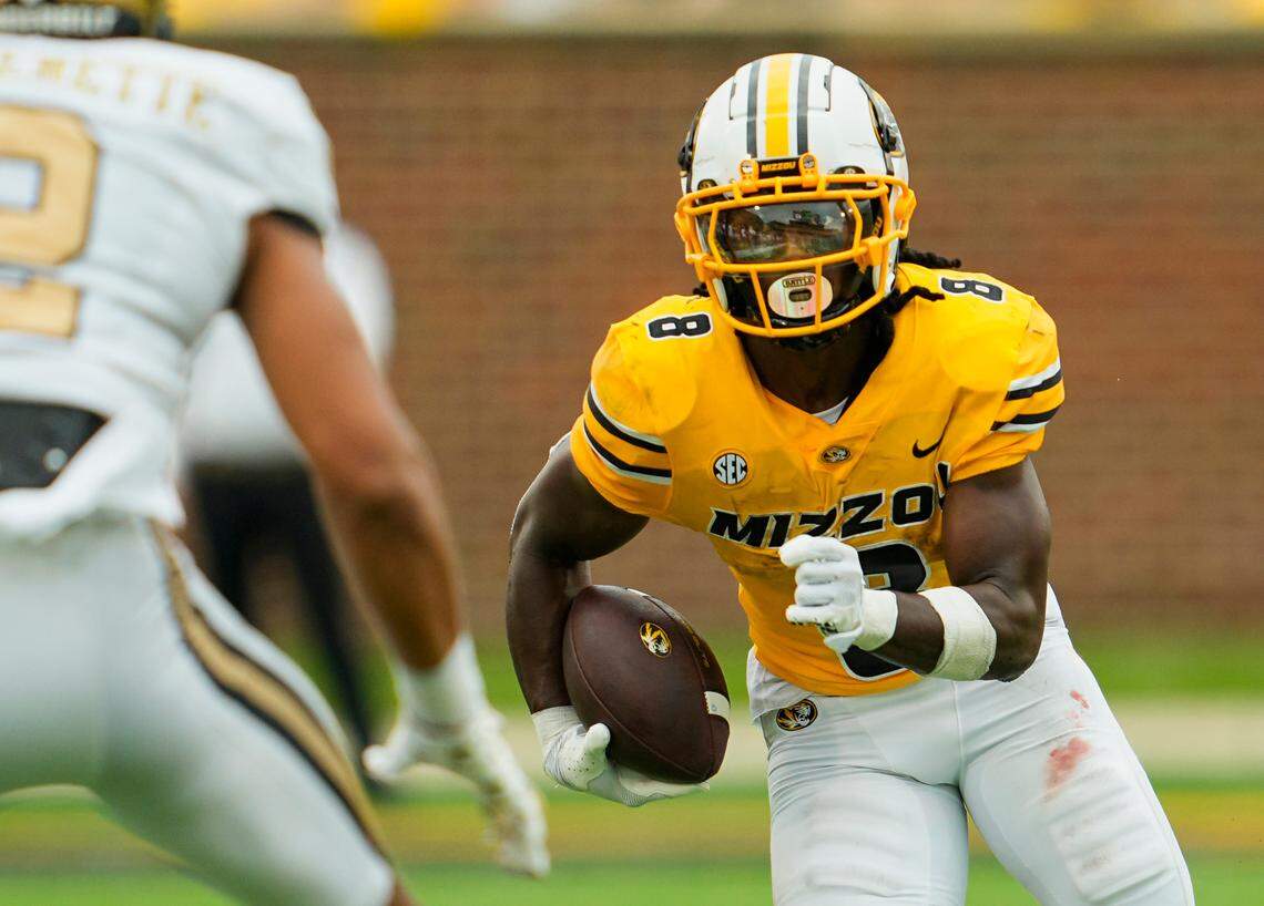 Missouri Tigers running back Nate Noel (8) runs with the ball against Vanderbilt Commodores linebacker Randon Fontenette (2) during the first half at Faurot Field at Memorial Stadium on Sept. 21, 2024.