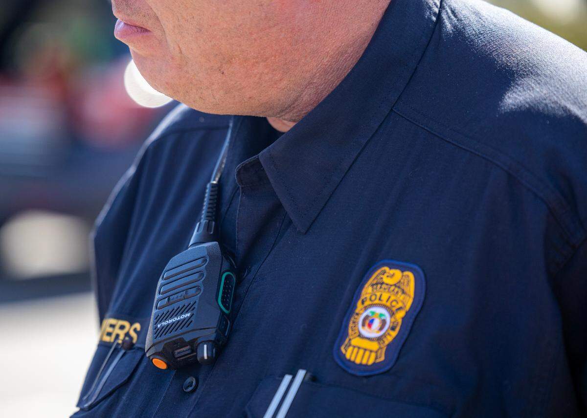 Police said a bystander pressed an emergency call button, like the one pictured here, on the radio of an officer who was injured in a collision along Troost Avenue Wednesday. The call summoned first responders to the scene, they said.