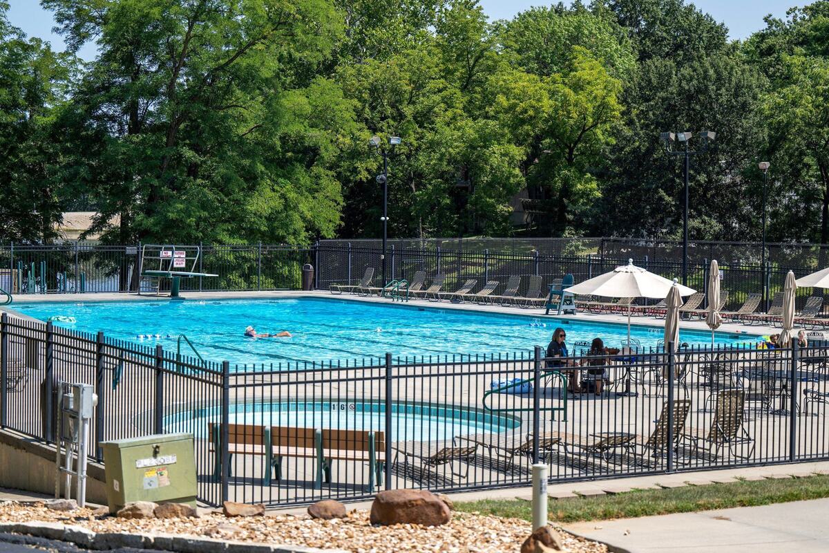 Residents are seen at the Coves community pool on Tuesday, Aug. 27, 2024, in Kansas City.