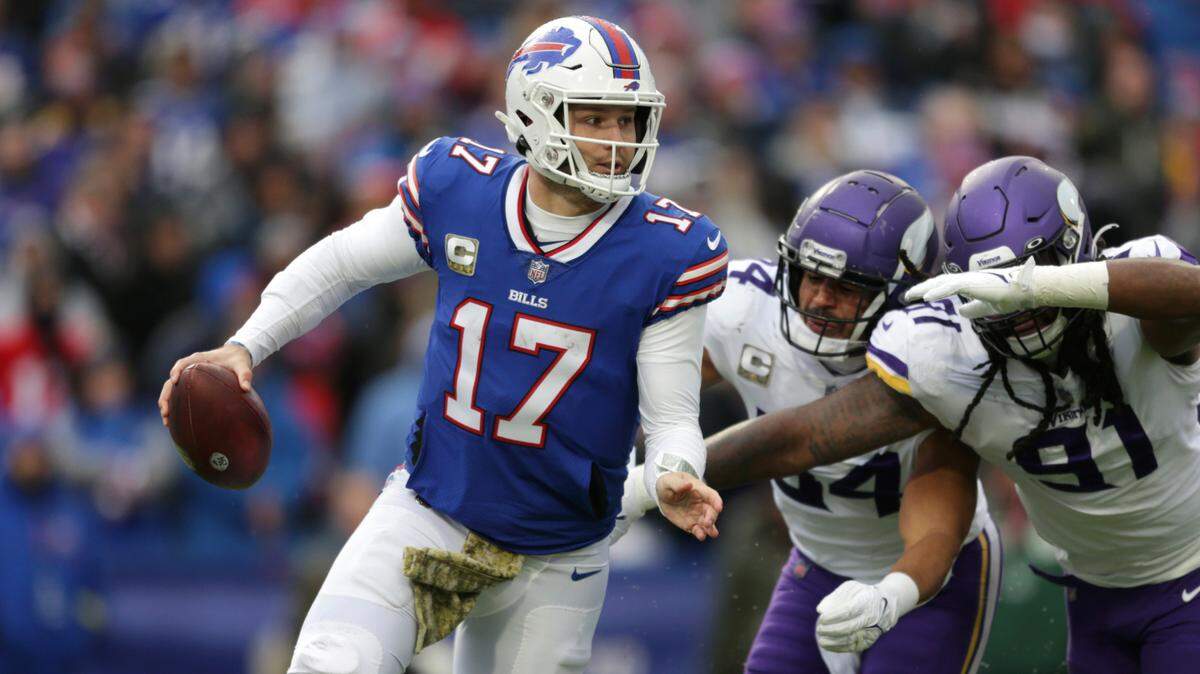 Buffalo Bills quarterback Josh Allen (17) runs with the ball under pressure from Minnesota Vikings linebackers Eric Kendricks (54) and Patrick Jones II (91) in the second half of an NFL football game, Sunday, Nov. 13, 2022, in Orchard Park, N.Y. (AP Photo/Joshua Bessex)