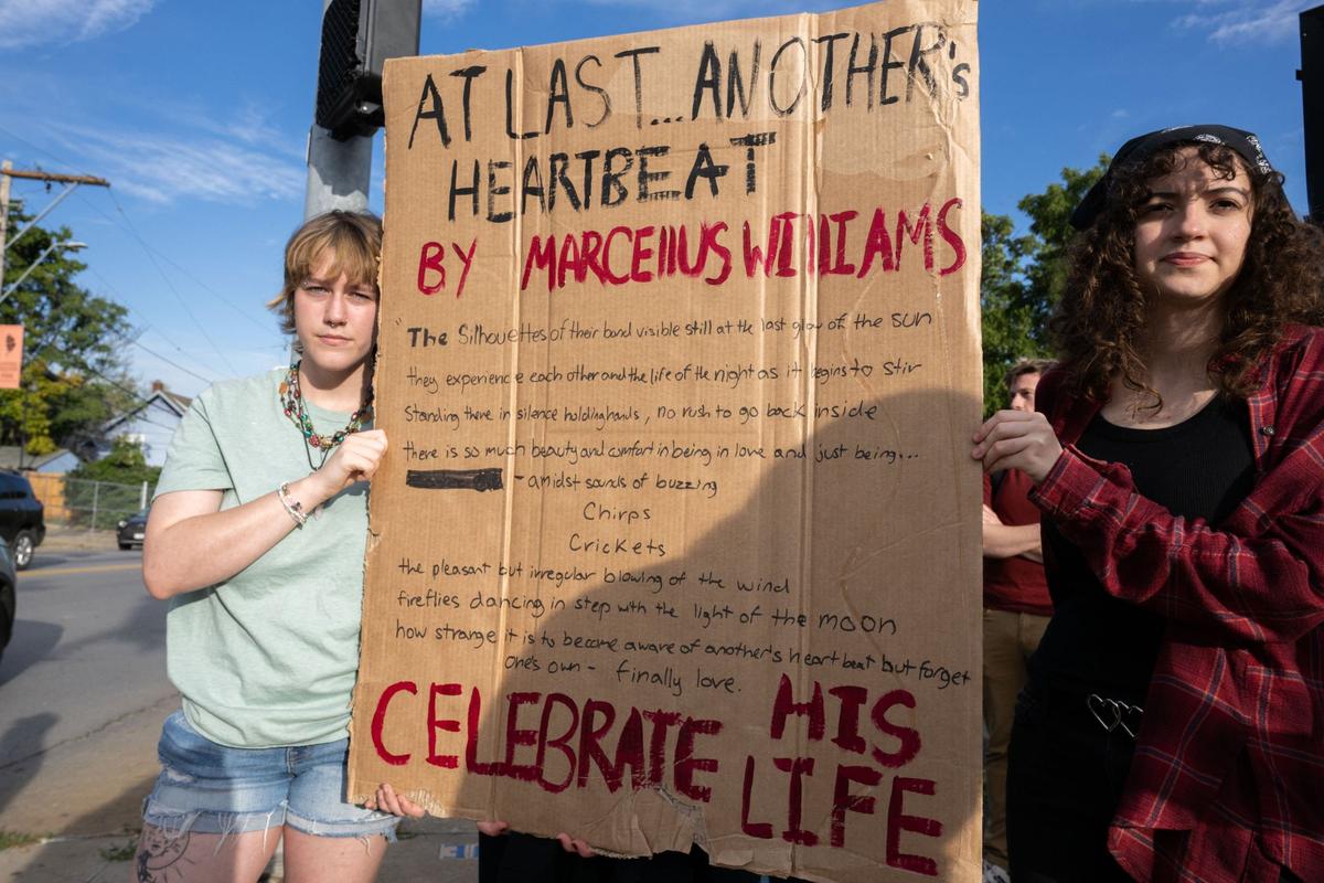 Isabel Widdoes and Sydney Osborne hold a sign with a poem written by Marcellus Williams at a protest at the corner of 39th and Troost in Kansas City on Tuesday, Sept. 24, 2024. Williams was a father, a poet and an Islamic leader in prison before he was executed on Sept. 24, 2024.