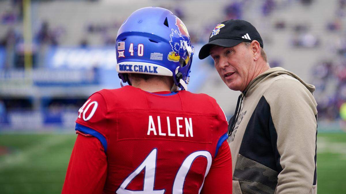 Kansas Jayhawks coach Lance Leipold talks with place kicker Tabor Allen (40) during warmups prior to a game against the Texas Tech Red Raiders at David Booth Kansas Memorial Stadium on Nov. 11, 2023.