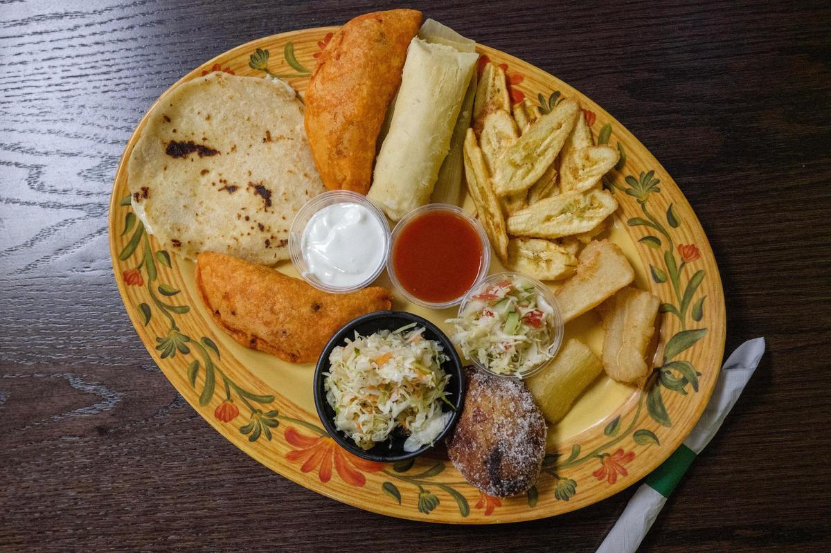 The Platillo Tipico at Las Palmas is a variety plate of Central Amercian favorites, including pupusas, a tamal and fried green banana chips, accompanied by house-made sauces and coleslaw.