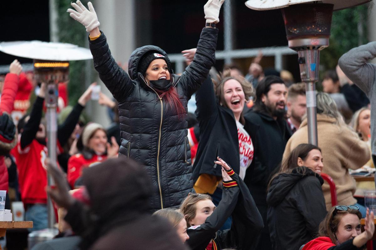 Chiefs fans celebrate after backup quarterback Chad Henne completed a 5-yard pass to Tyreek Hill to get the first down that allowed the Chiefs to run out the clock Sunday, Jan. 17, 2021.