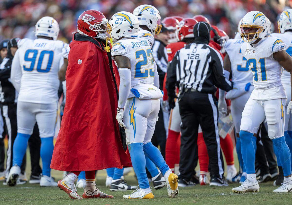 Kansas City Chiefs running back Isiah Pacheco (10) gets into it with Los Angeles Chargers safety Tony Jefferson (23) after Jefferson laid a hit on Kansas City Chiefs wide receiver Tyquan Thornton (80) and a skirmish broke out in the second half on Sunday, Dec. 14, 2025 at GEHA Field at Arrowhead Stadium in Kansas City.