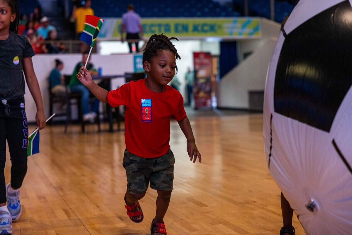 David Hemphill chases a blow up soccer ball as they wave a South African flag in the air at the KCK Mexico v. South Africa Watch Party hosts at Memorial Hall  on Thursday, June 11, 2026.