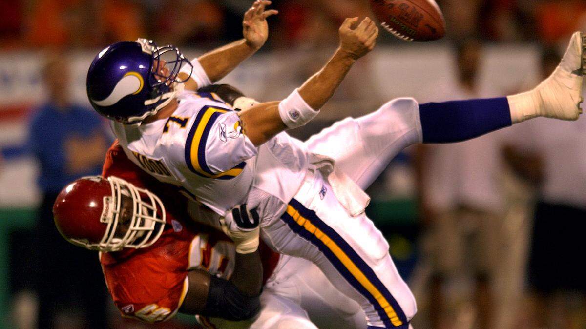 Former Chiefs defender Jimmy Wilkerson (bottom) pulls down Vikings quarterback Juston Wood (7) for a sack during the fourth quarter of the Chiefs-Vikings preseason game on Aug. 16, 2003.