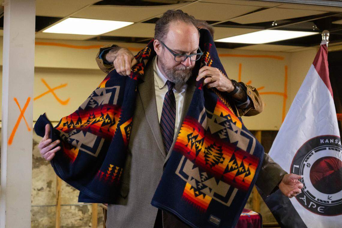 Scott Brewer is presented with an honorary blanket in the basement of Grinter Chapel during a ceremony on Thursday, March 12, 2026, in Kansas City. Brewer helped facilitate the gifting of the deed to the former church property to the Kansas Delaware Tribe of Indians, Inc. 