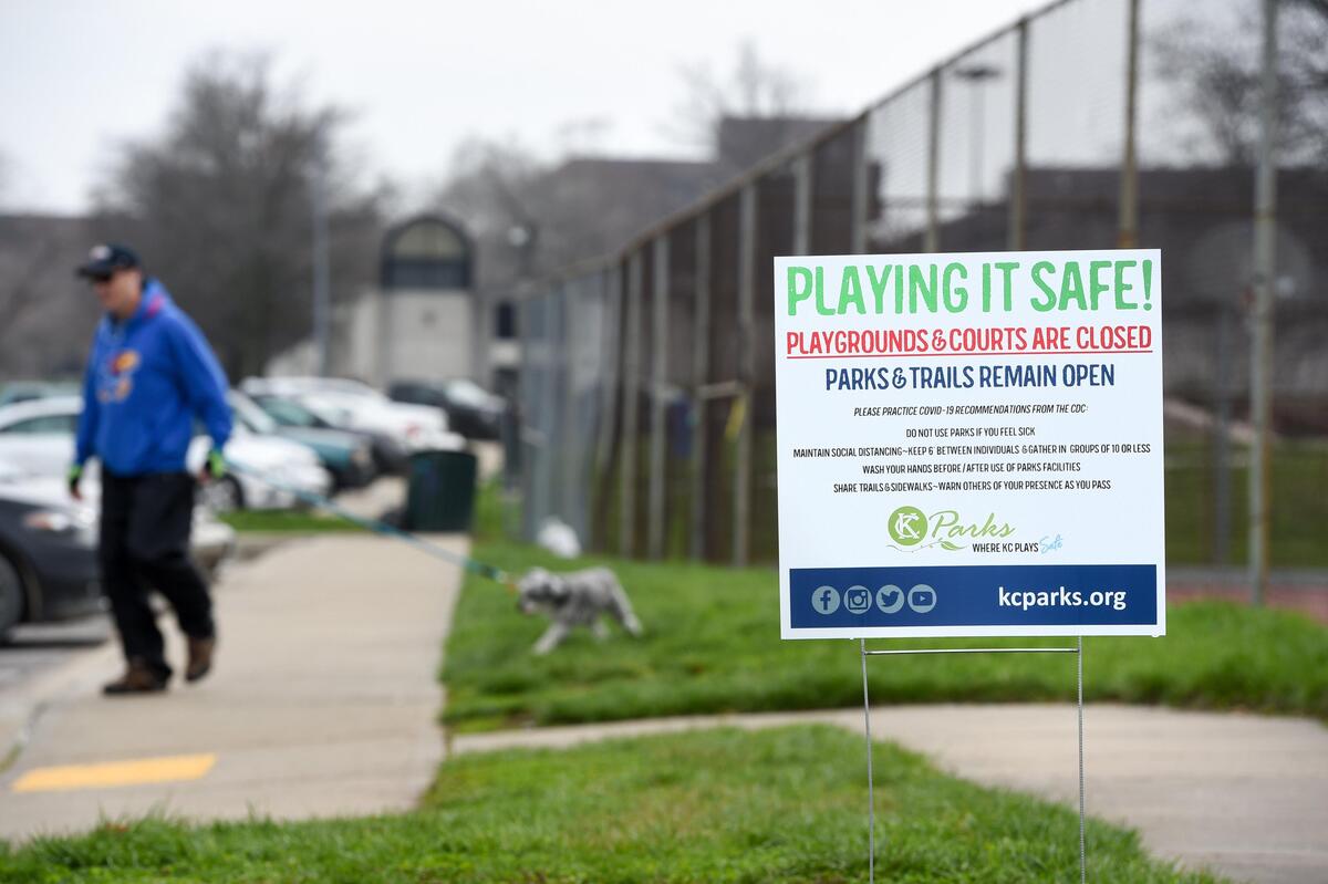 Signs from Kansas City Parks and Recreation are posted in Penn Valley Park alerting people that the playground and tennis courts are closed, but the park and trails remain at open due to the coronavirus pandemic on Friday, March 27, 2020 in Kansas City. CORONAVIRUSKC
