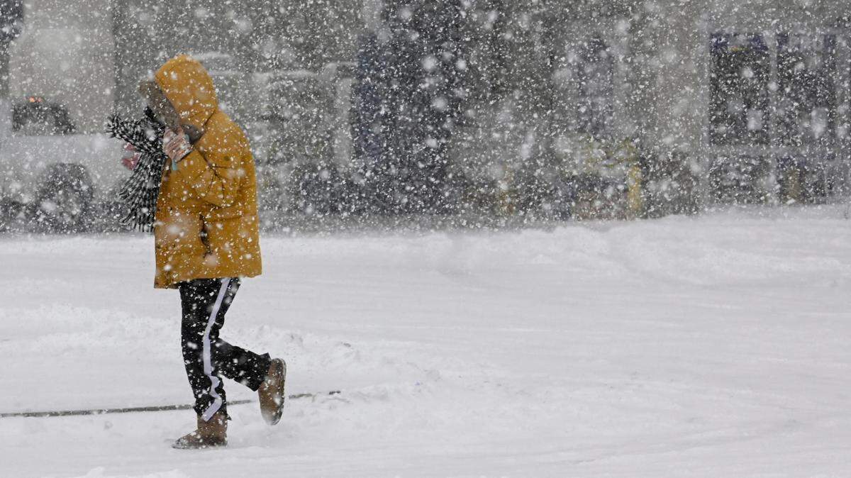 A shopper braved the snowstorm to head to a grocery store Thursday, Feb. 17, 2022, in Roeland Park.