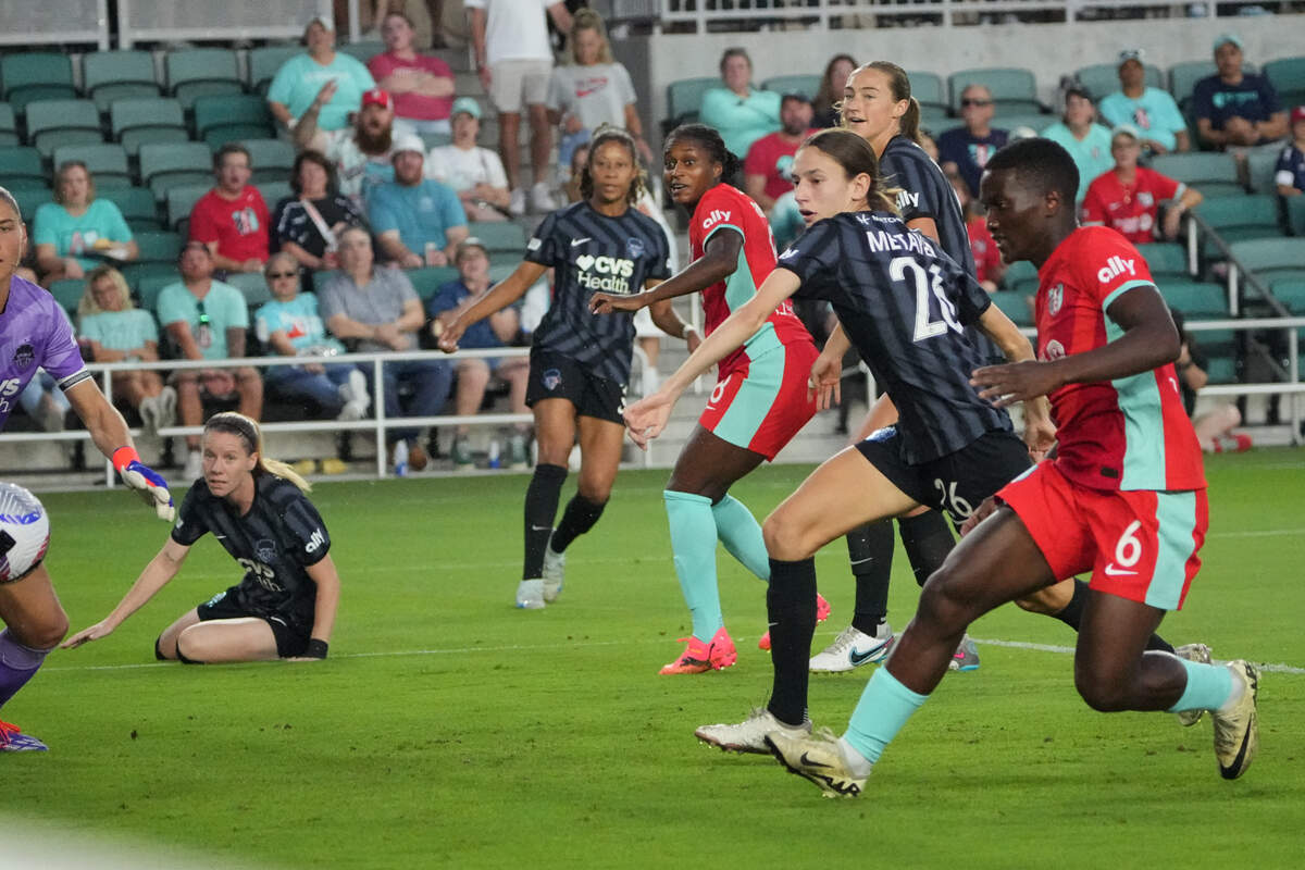 Kansas City Current forward Nichelle Prince (far right) scores past Washington Spirit goalkeeper Aubrey Kingsbury during Friday night’s match at CPKC Stadium.