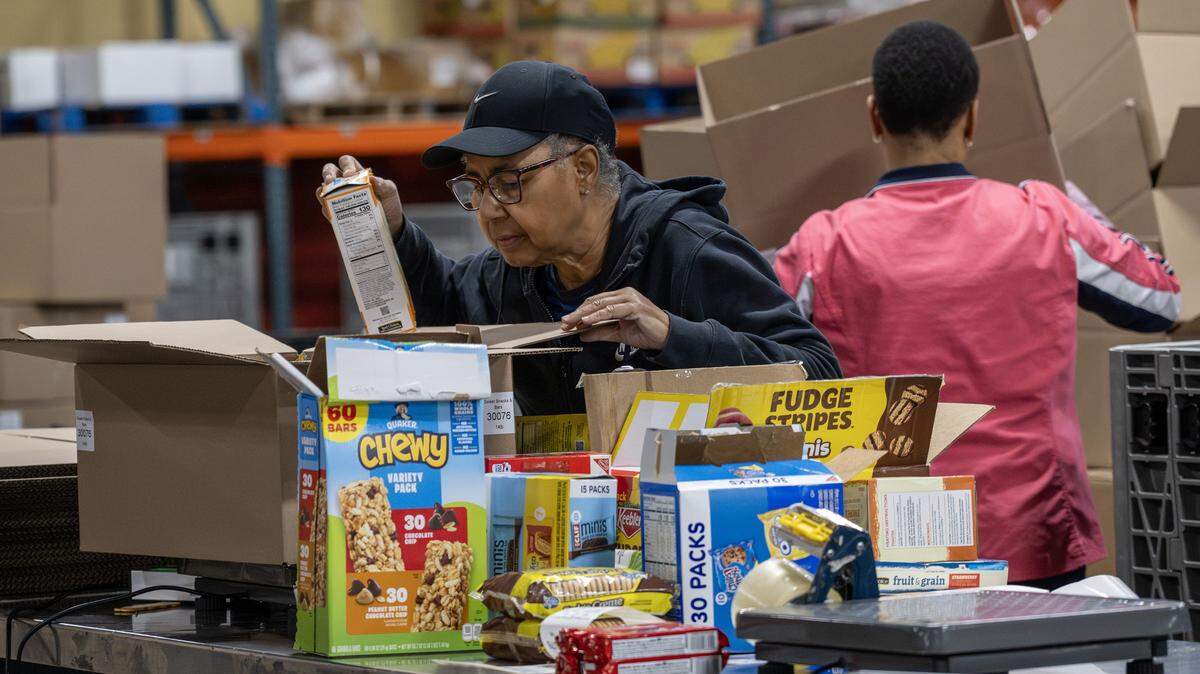 A Harvesters volunteer packs boxed goods at the distribution warehouse last month in Kansas City. The food bank is working to supply local pantries amid the government shutdown affecting SNAP benefits.