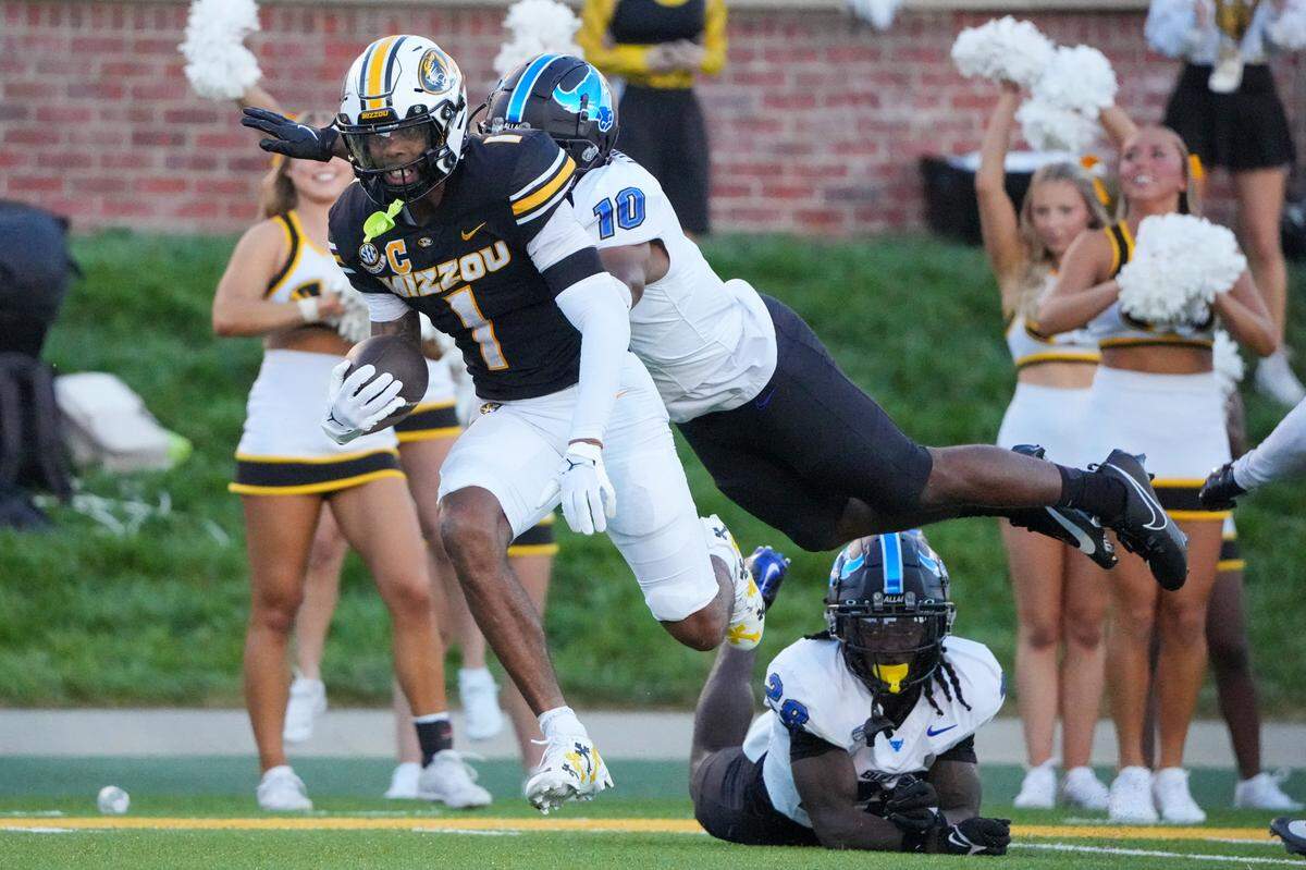 Missouri Tigers wide receiver Theo Wease Jr. runs the ball as Buffalo Bulls safety Marcus Fuqua tries to tackle him during Saturday’s game at Faurot Field at Memorial Stadium.