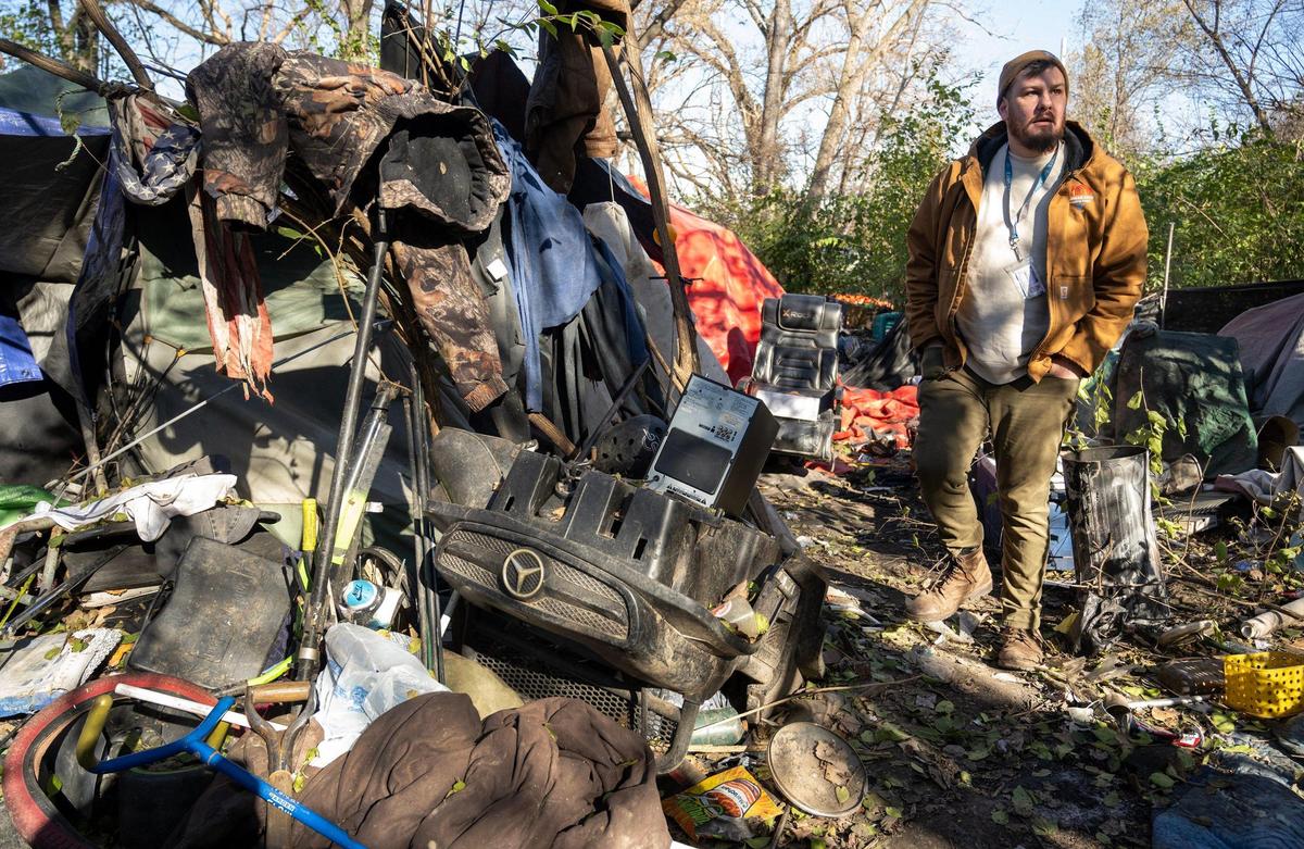 Nick Allen, the street outreach coordinator for the Office of Unhoused Solutions, tasked with getting people out of homelessness, visits a homeless camp on a cold December morning.