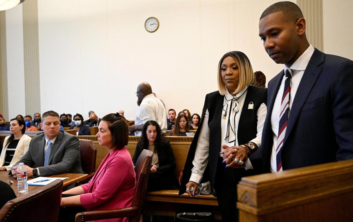 Led by Dion Sankar, assistant prosecuting attorney, Laurie Bey, mother of Cameron, heads to the witness stand to give a statement. Former Kansas City police detective Eric DeValkenaere, seated at table, left, was sentenced to six years in the Dec. 3, 2019, killing of Cameon Lamb. Circuit Court Judge J. Dale Youngs announced the sentence Friday, May 4, 2022.