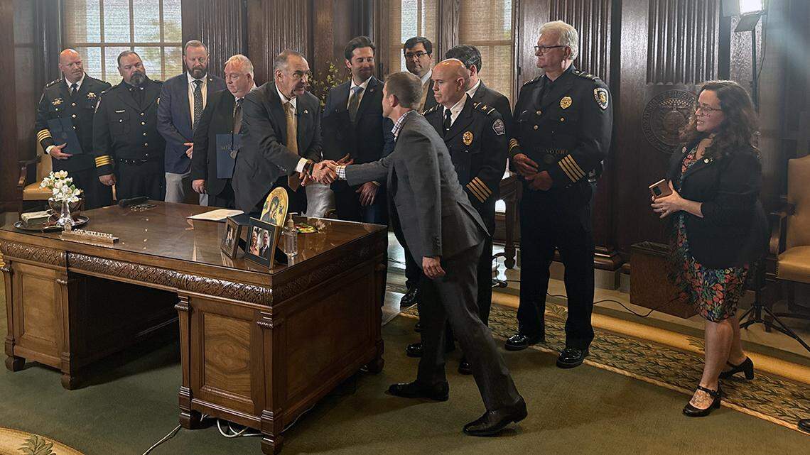 Gov. Mike Kehoe shakes the hand of marijuana industry lobbyist Steve Tilley at the signing of H.B. 2641 on April 23 in Jefferson City.
