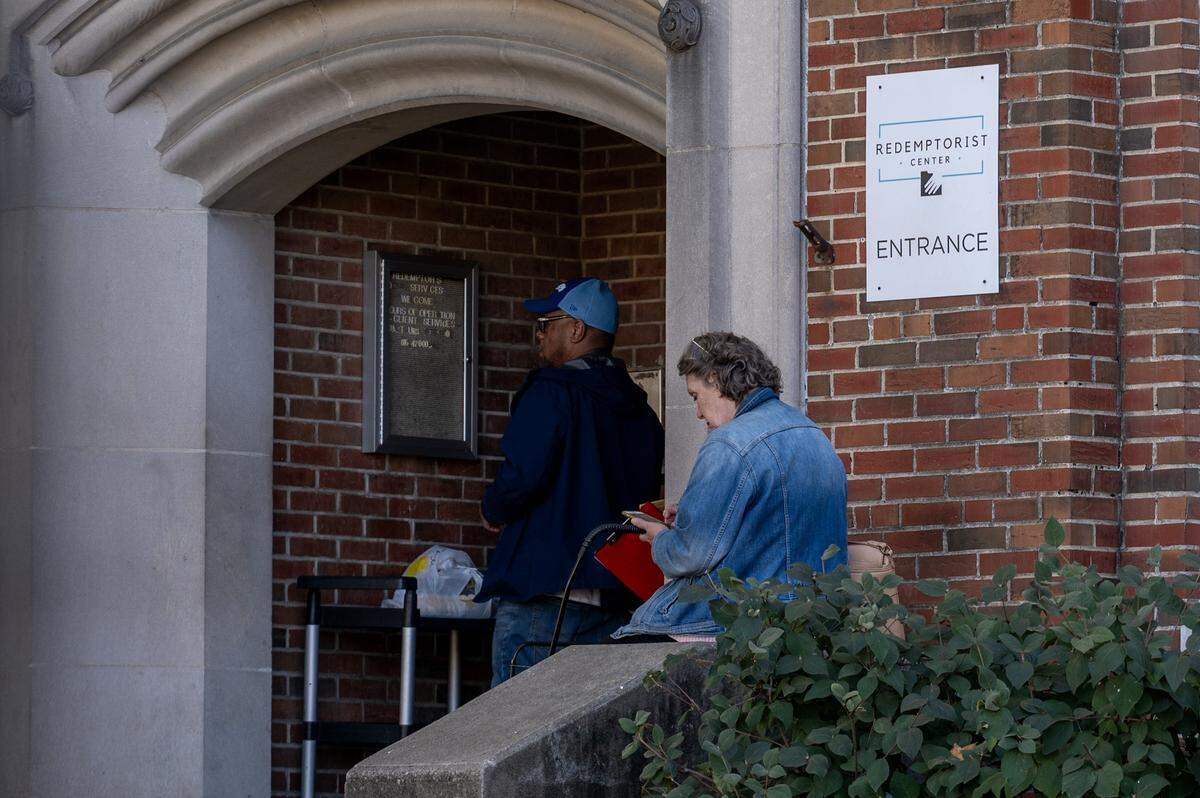 People wait outside of Redemptorist Center on Monday, Nov. 3, 2025, in Kansas City. Food pantries across the region are struggling to meet demand as many families face reduced or frozen SNAP benefits.