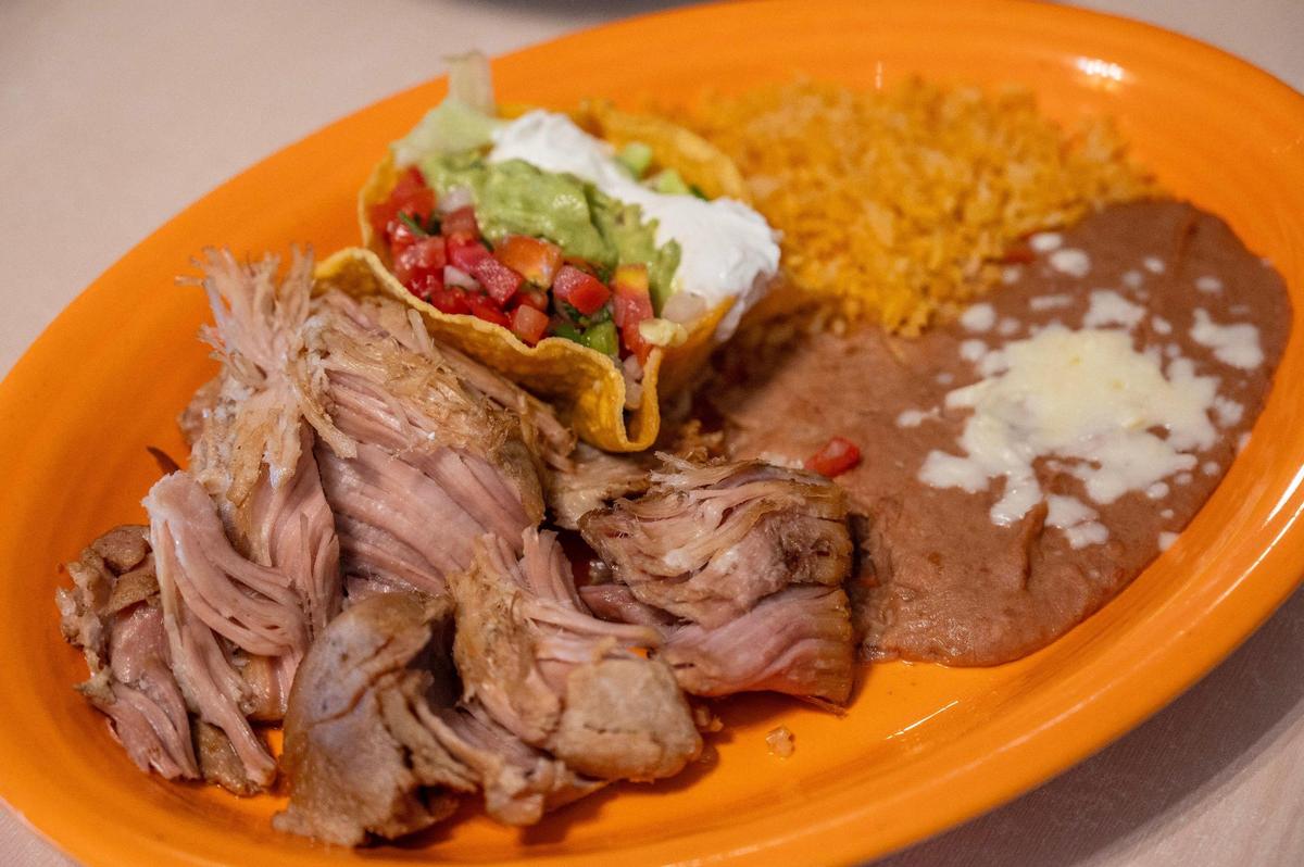The hefty carnitas ($16) at Dos Reales Authentic Mexican Restaurant are prepared according to a secret recipe with ingredients that might surprise customers.