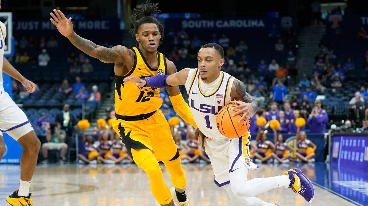 LSU guard Xavier Pinson (1) dries past Missouri guard DaJuan Gordon (12) during the first half of an NCAA college basketball game at the Southeastern Conference tournament in Tampa, Fla., Thursday, March 10, 2022. (AP Photo/Chris O’Meara)